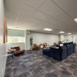 Spacious lounge area at Waterside Recovery Center West in Westborough with comfortable seating and natural light