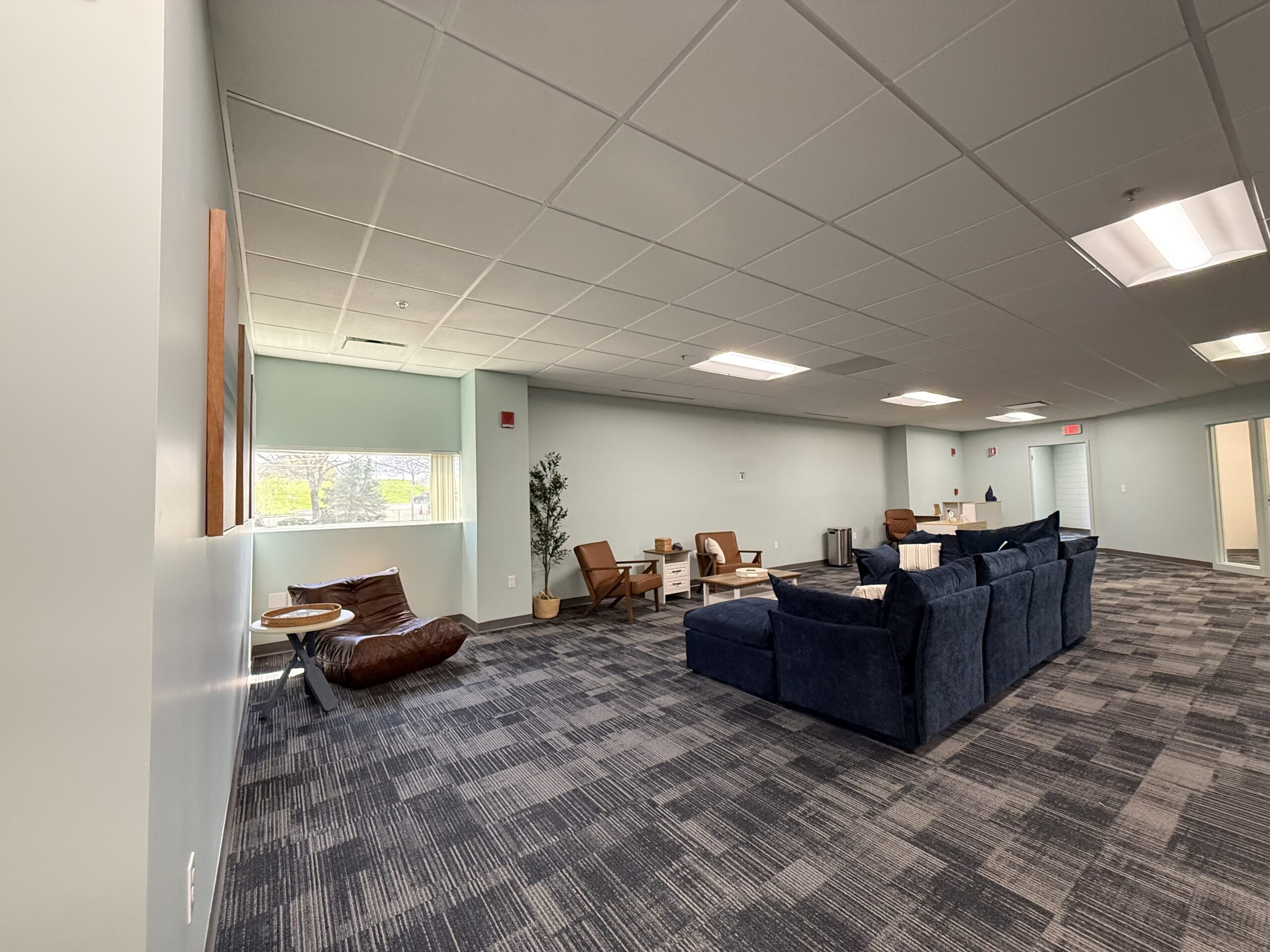 Spacious lounge area at Waterside Recovery Center West in Westborough with comfortable seating and natural light